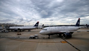 ARLINGTON, VA - AUGUST 13: A US Airways jet taxies at Ronald Reagan Washington National Airport August 13, 2013 in Arlington, Virginia. The U.S. Justice Department, and attorneys general from six states, filed legal actions today attempting to prevent the planned merger of US Airways and American Airlines as a violation of antitrust law. (Photo by Win McNamee/Getty Images)